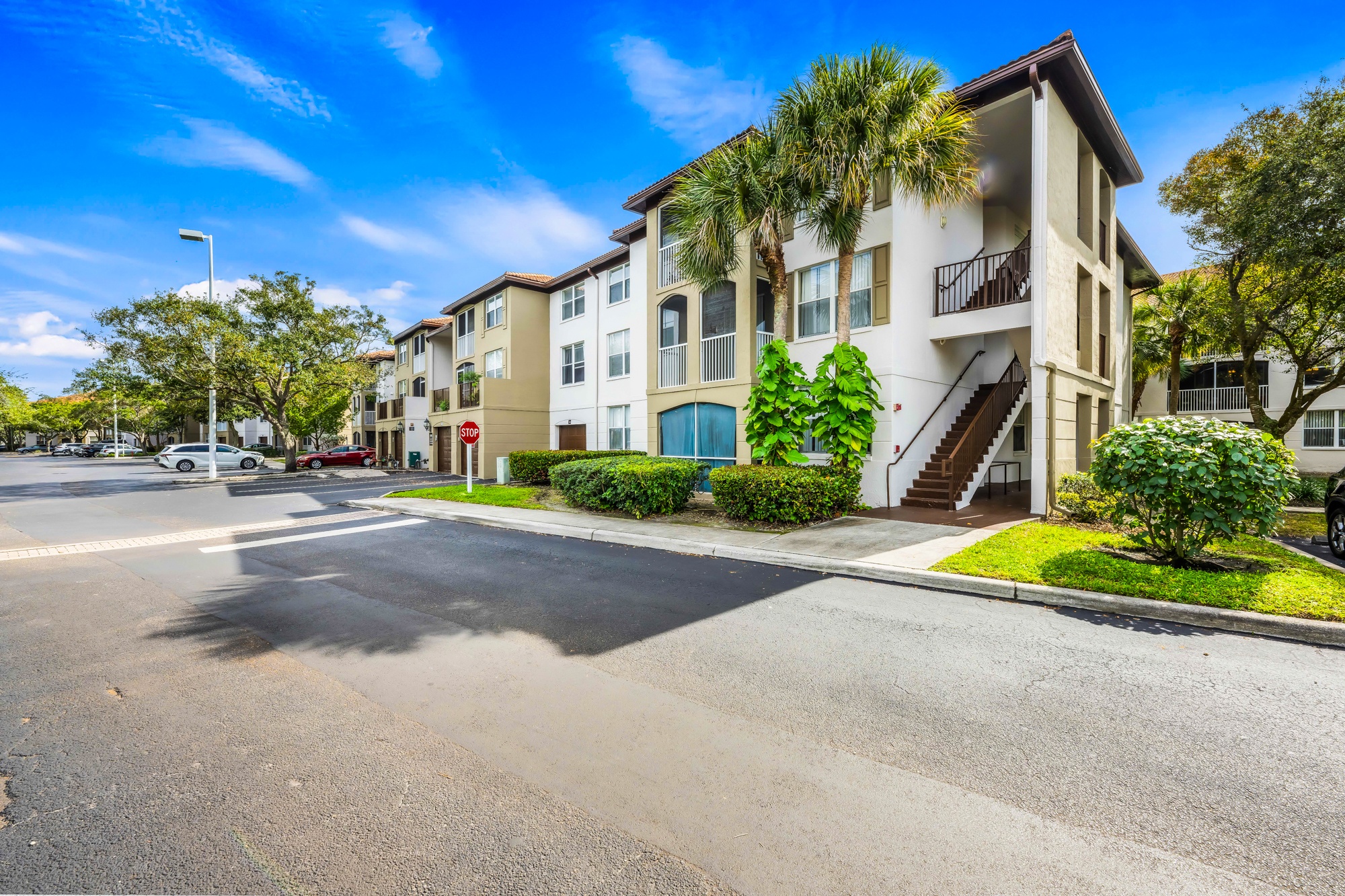 A sunny day at a residential area with apartment buildings and a clear blue sky.
